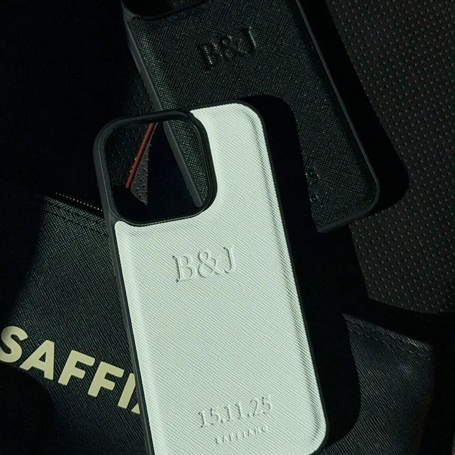 Two phone cases with 'B&J' branding on a black surface